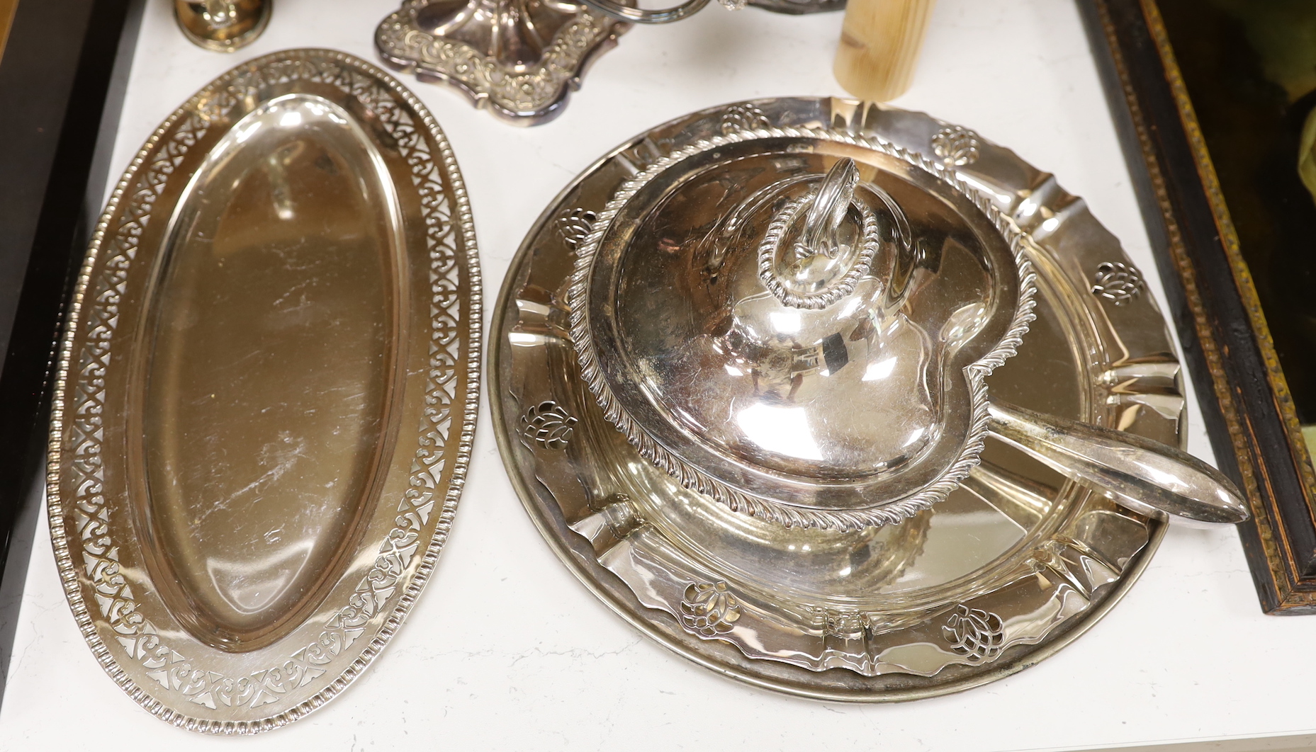 A selection of assorted plated ware, to include a pair of candlesticks, a pair of sauceboats, etc. tallest 28.5cm
